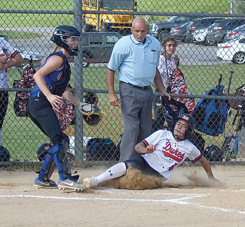 Marlboro’s Ella Leduc slides into home plate as Chester catcher Caroline Farrell looks for a throw during the Section 9 Class B championship softball game on June 11, 2021.
